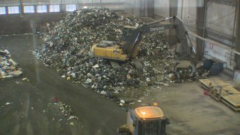 That waste is scooped up and placed on a conveyor belt